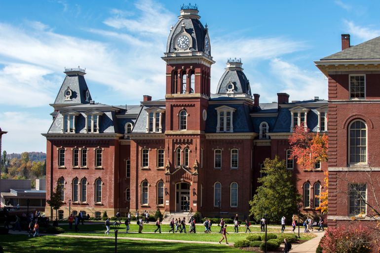 Woodburn Hall on WVU's downtown campus with groups of students walking in front of it.